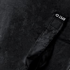 A black umbrella featuring a textured surface and a strap with a logo.