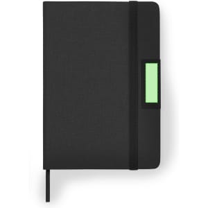 A black notebook with a textured cover, featuring a green rectangular label and an elastic closure.