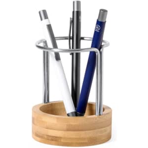 A stylish pencil holder with a wooden base and a metallic ring, featuring three pens in various colours.