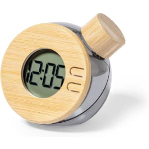 A round desk clock with a bamboo face and a silver body, featuring a digital display and a wooden top knob.