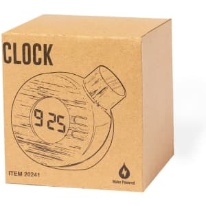 A round, water-powered desk clock in a cardboard box, featuring a digital display for the time.