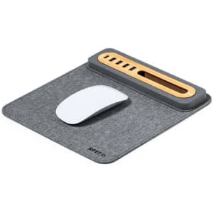 A grey multifunction mousepad with a wooden and grey accessory holder, featuring a white mouse on top.
