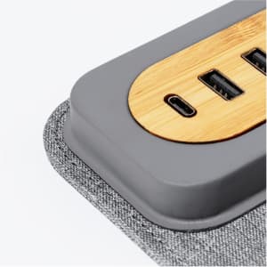 A multifunction mousepad in grey with a bamboo section and multiple USB ports.