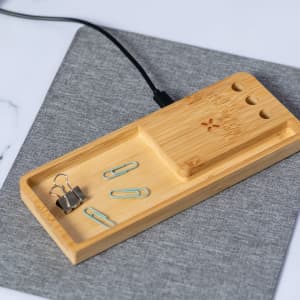 A bamboo multifunction mousepad with a grey fabric surface, featuring compartments for clips and stationery.