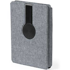 A grey notepad with a textured finish and a black elastic closure, featuring a circular design.