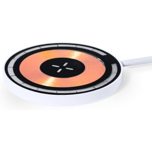 A wireless charger in white and copper, featuring a circular design with a cable attached. It includes a logo.