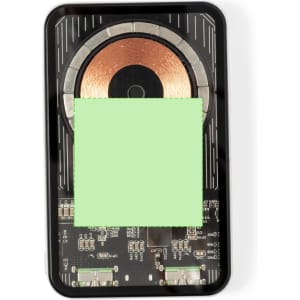 A black power bank with a circular wireless charging pad, displaying circuitry on its surface. It includes a logo.