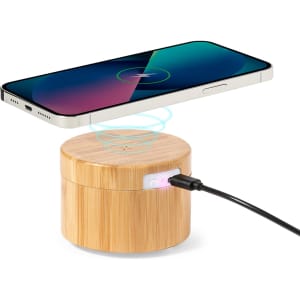 A bamboo wireless charger with a smartphone above, featuring a glowing LED indicator and a cable connection.