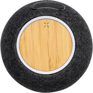 A round black speaker with a bamboo centre and a small logo on top, designed for phone and technology use.