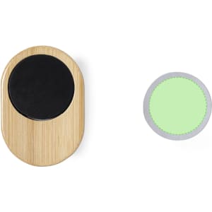 A bamboo phone holder with a black circular top, accompanied by a green circular adhesive pad.