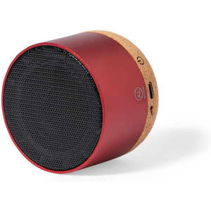 A red speaker with a cork base and a mesh grille, featuring a logo and connectivity ports.