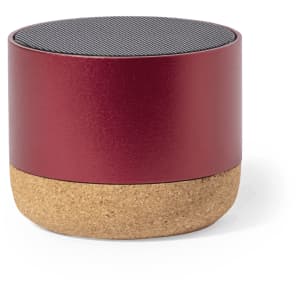 A round speaker in a metallic red finish with a cork base. It features a textured top surface.
