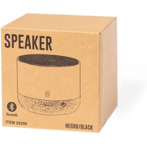 A black Bluetooth speaker in a brown cardboard box with a simple design and a visible brand logo.