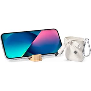A charging cable in a light grey pouch, with a phone resting on a wooden stand, featuring a colourful screen.
