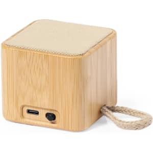 A bamboo speaker with a fabric top, featuring a USB-C port and a rope handle for portability.