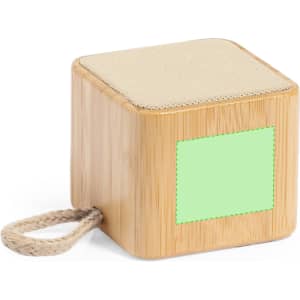 A wooden cube speaker in a natural finish with a fabric top and a rope handle, featuring a blank area for custom branding.