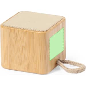 A bamboo cube speaker with a fabric top and a rope handle, featuring a logo on one side.