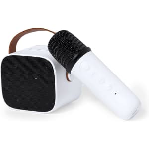 A white karaoke speaker with a black microphone and a brown handle, featuring control buttons on the side.