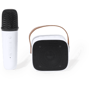 A white karaoke speaker with a black front grille and a microphone beside it, featuring a strap.