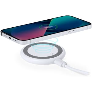 A wireless charger in white, with a smartphone positioned above it, illustrating the charging process.
