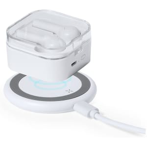 A wireless charger with a circular design in white, featuring a clear case holding wireless earbuds.