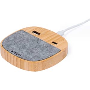 A wireless charger with a wooden base and grey felt top, featuring USB ports for connection.