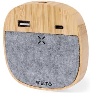 A wireless charger with a bamboo exterior and grey felt front, featuring USB and USB-C ports.