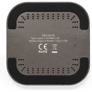 A wireless charger with a grey surface and a black rim, featuring various vents and a logo.