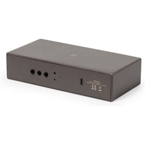 A sleek brown multifunction alarm clock with multiple ports and a logo on the surface.
