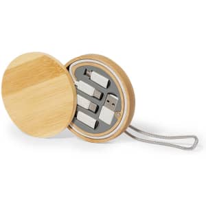 A bamboo case opens to reveal a set of charging cables in grey and silver, featuring a branded logo.