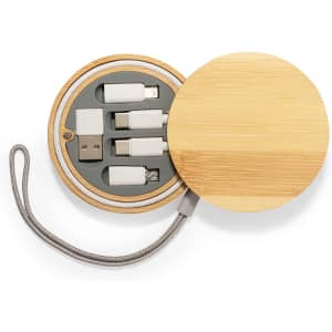 A round bamboo case containing various charging cables in white, with a metallic braided connector.