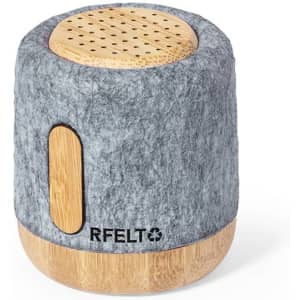 A grey felt wireless speaker with a bamboo base, featuring a logo on the side and a textured top.