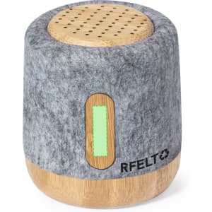 A grey felt speaker with a bamboo base and a logo, featuring a circular perforated top for sound emission.