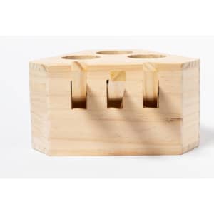 A wooden hexagonal game block with three circular holes on the top, featuring a light natural finish.