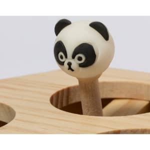A wooden toy featuring a panda head on a stick, with black and white colouring, set on a light wooden base.