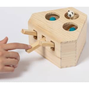 A wooden toy with four holes, featuring blue balls and a panda, with two levers for interaction.