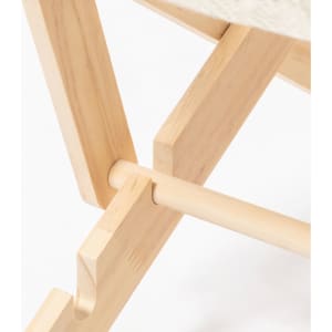 A wooden detail of the Diny Pets Chair, featuring light coloured timber and a sturdy design. It has a branding logo.