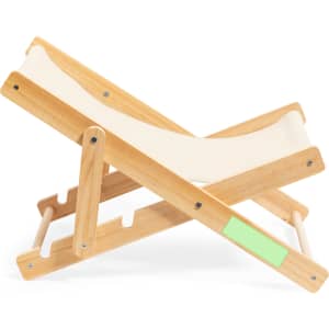 A folding chair made of light wood with a cream fabric seat, featuring a small area with a logo.