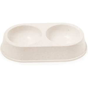 A double pet bowl in light beige, featuring two rounded compartments and a raised base. It has a brand logo.