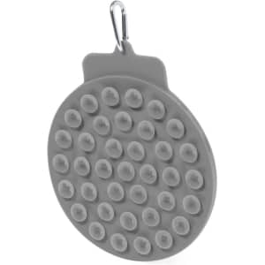A grey Pudle Feeding Pillow with numerous suction cups attached. The product features a clip for easy hanging.