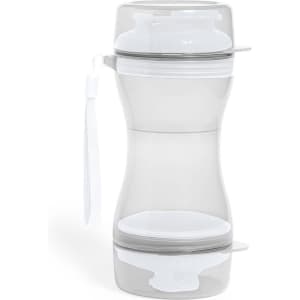 A sleek, clear drink bottle featuring a removable bottom compartment, complete with a wrist strap.