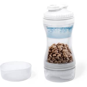 A drink bottle with a white body and a transparent section filled with pet food, alongside a separate white lid.