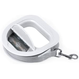 A grey pet lead with a white handle and a retractable design, featuring a paw print pattern on the tape.