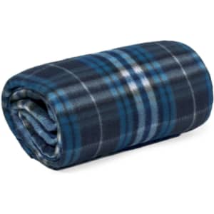 A rolled plaid blanket featuring shades of blue and grey, with a soft, cosy texture. The blanket has a branding logo.