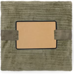 A soft, olive green blanket with a rectangular label and ribbon, featuring a textured surface.
