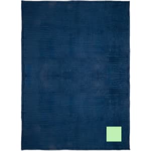 A navy blue blanket with a textured surface and a small green logo in the corner.