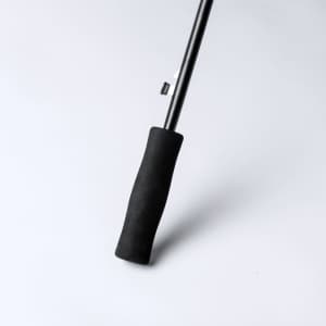 A black umbrella handle with a textured grip, featuring a metallic pole and a locking mechanism.