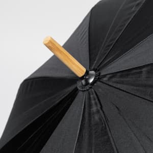 A black umbrella with a wooden handle, featuring a sleek design and a smooth canopy.