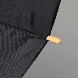 A black umbrella featuring a wooden handle and a smooth fabric canopy. It includes a branding logo.