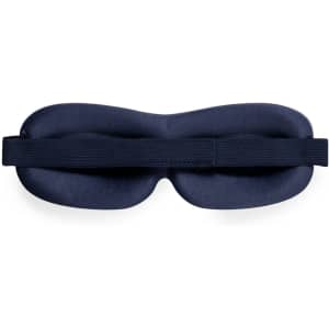 A navy blue travel eye mask with a soft padded design and an adjustable strap, featuring a branding logo.